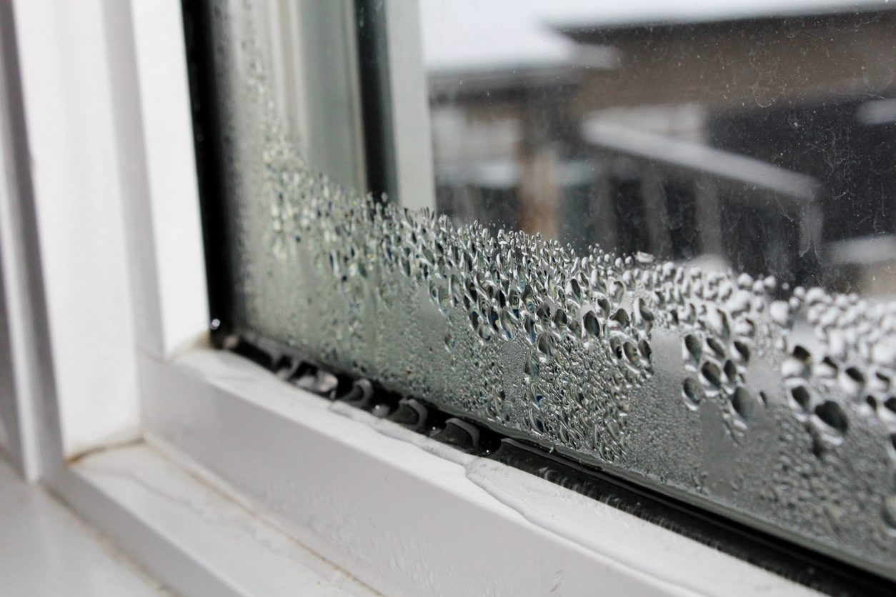 Water entering a basement through a window well during heavy rain